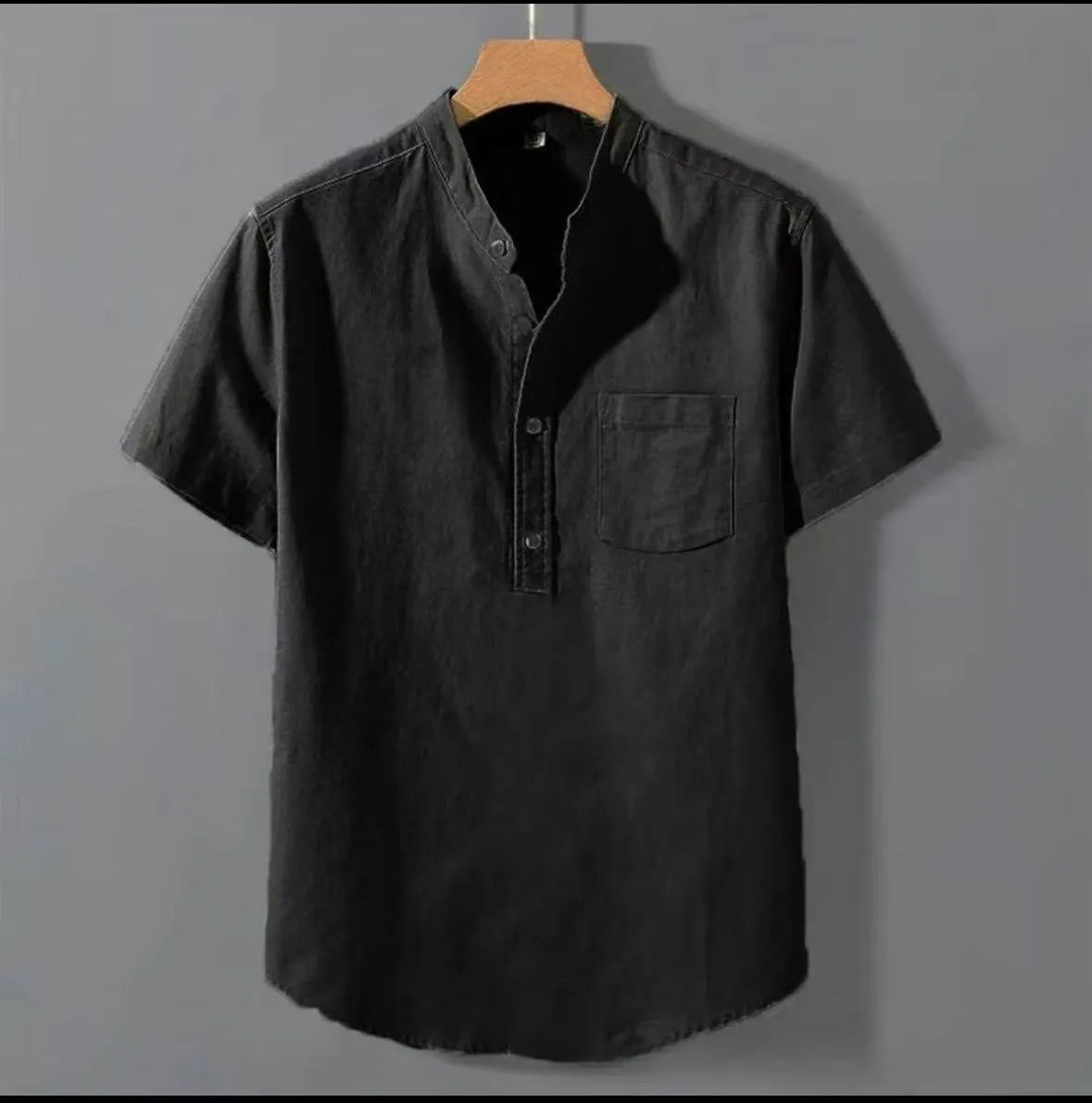 Men's beige loose-fit linen short sleeve shirt with a stand collar on a hanger.