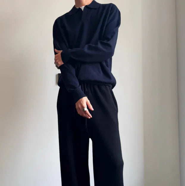 Men's loose-fit lapel-collar wool sweater in navy blue, laid flat showing front design.