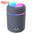 Pink USB mini humidifier with LED lights and water tank on desk