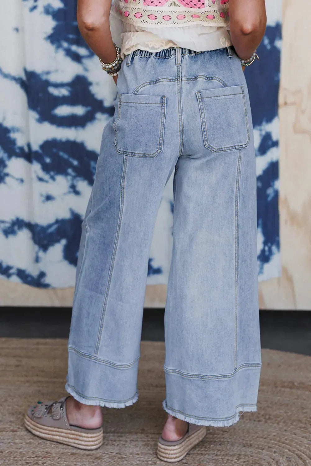 Beau blue wide leg denim trousers with drawstring waist, raw hem finish, and visible seam detailing