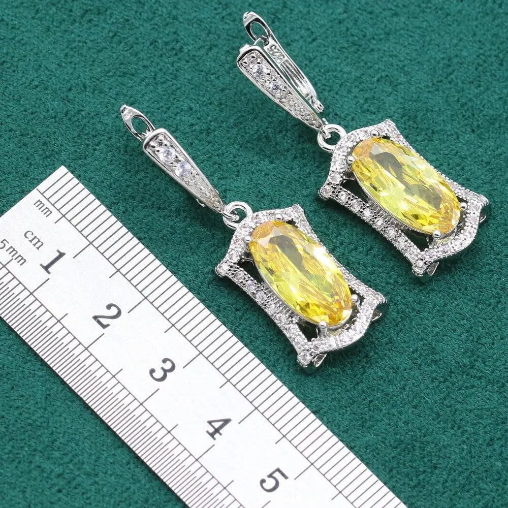 Yellow and olive anti-allergy alloy zircon jewellery set showing necklace, earrings, ring, and bracelet on a dark background.
