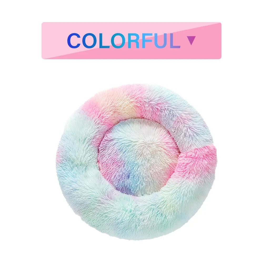 Fluffy donut-shaped pet bed in long plush fabric, shown in a light grey colour.