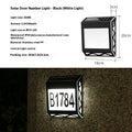 Black solar-powered doorplate light with LED illumination for house numbers measuring 180x50x200mm