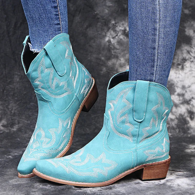 Blue women's cowboy ankle boots with embroidery, a pointed toe, and a low wedge heel.