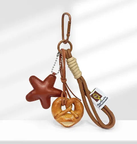 Handbag pendant charm with handmade soda bread design patterns including brown star, croissant, and bagel