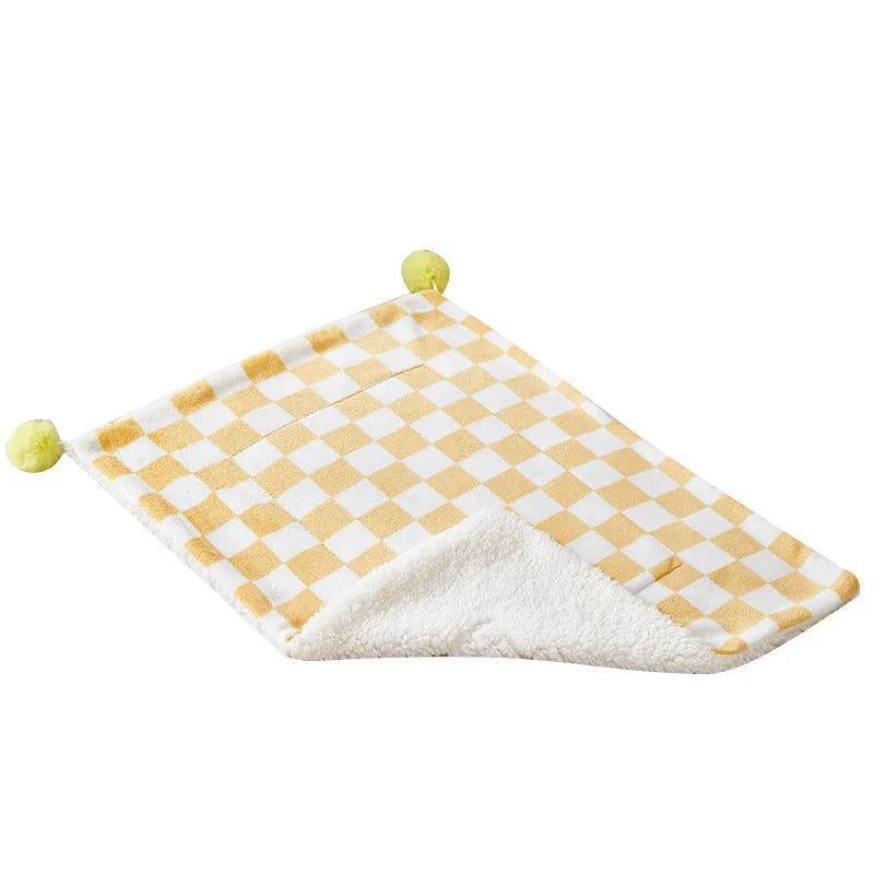 Green plaid plush pet blanket for dogs and cats on a sofa
