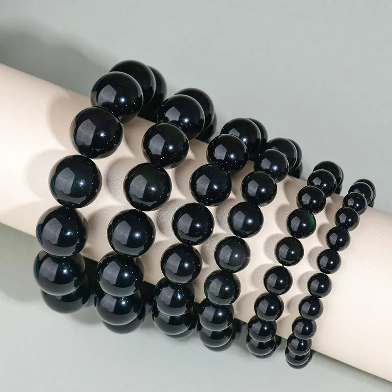 Hand-woven obsidian bracelet with round beads and engraved birth year detail for couples