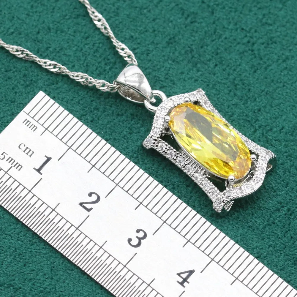 Yellow and olive anti-allergy alloy zircon jewellery set showing necklace, earrings, ring, and bracelet on a dark background.