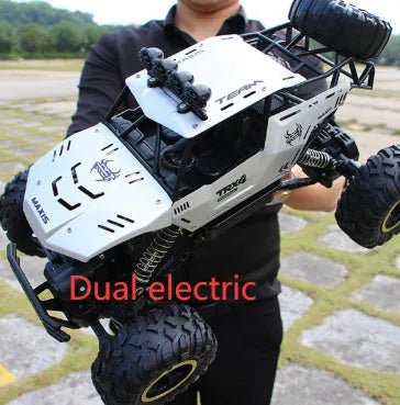 Black and silver remote control climbing cars with 2.4G wireless controller on a rough surface.