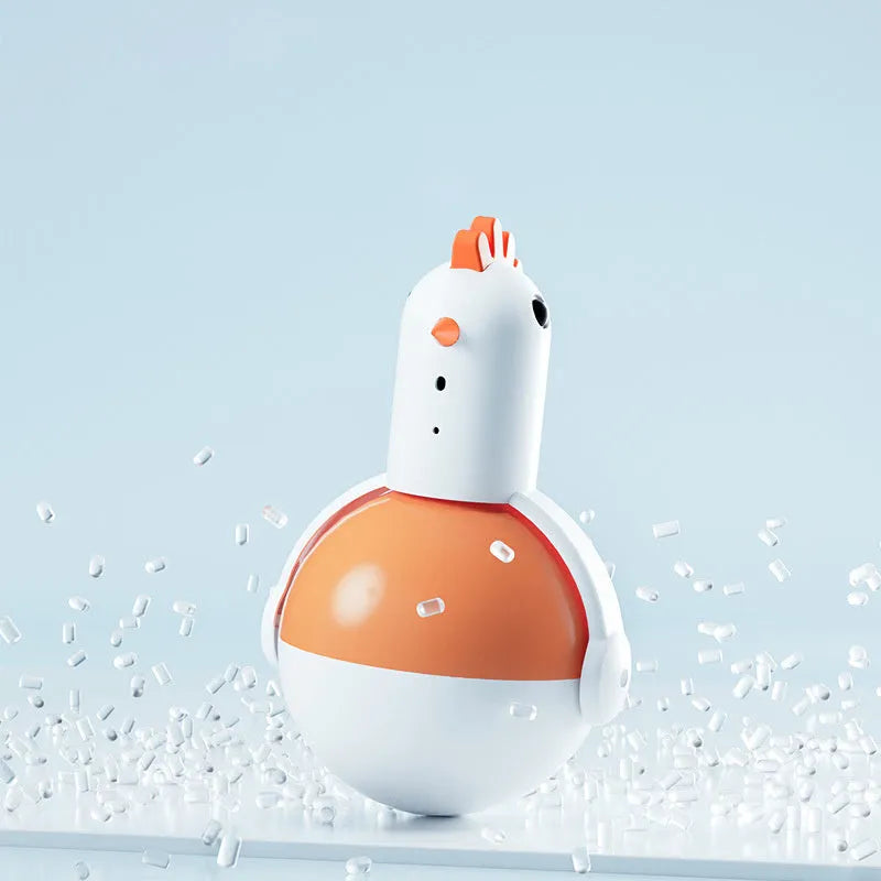 Green or orange electric chicken-shaped cat toy with laser and sound features on a flat surface.