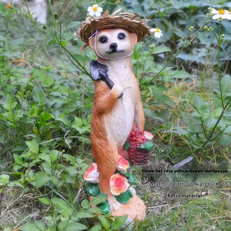 Three small straw hat mongoose garden ornaments: one with a baby, one holding a rake, one holding a shovel.