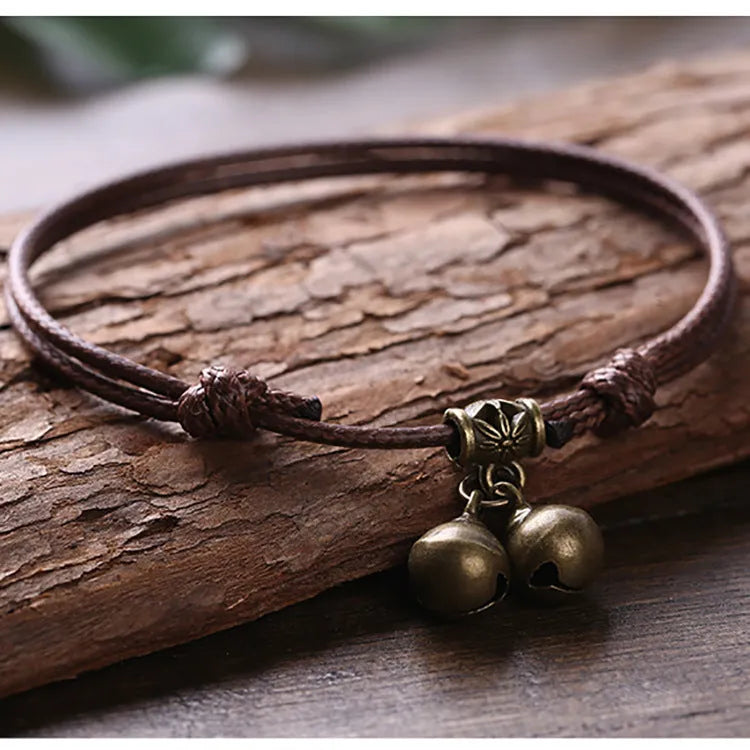 Adjustable nylon dog collar with a choice of brass bell or brass buckle in black, red, or coffee colour.