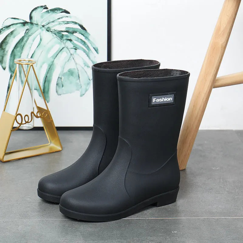Women's mid-calf PVC rain boot in black, shown with a low heel and optional wool lining.