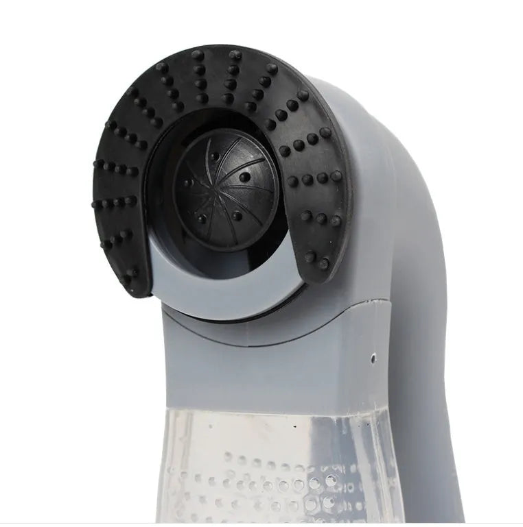 Grey portable electric pet hair removal brush with soft rubber head for grooming dogs and cleaning sofas.