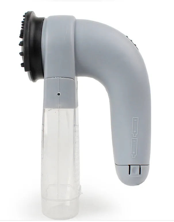 Grey portable electric pet hair removal brush with soft rubber head for grooming dogs and cleaning sofas.