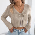 Women's khaki hollow-out lace-up coat showing front closure and short length styling