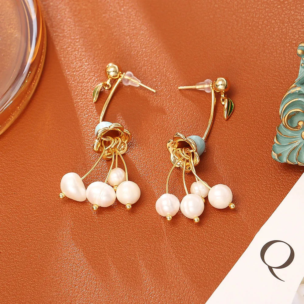 Natural baroque pearl ear studs in lily flower shape with gold plating on copper base