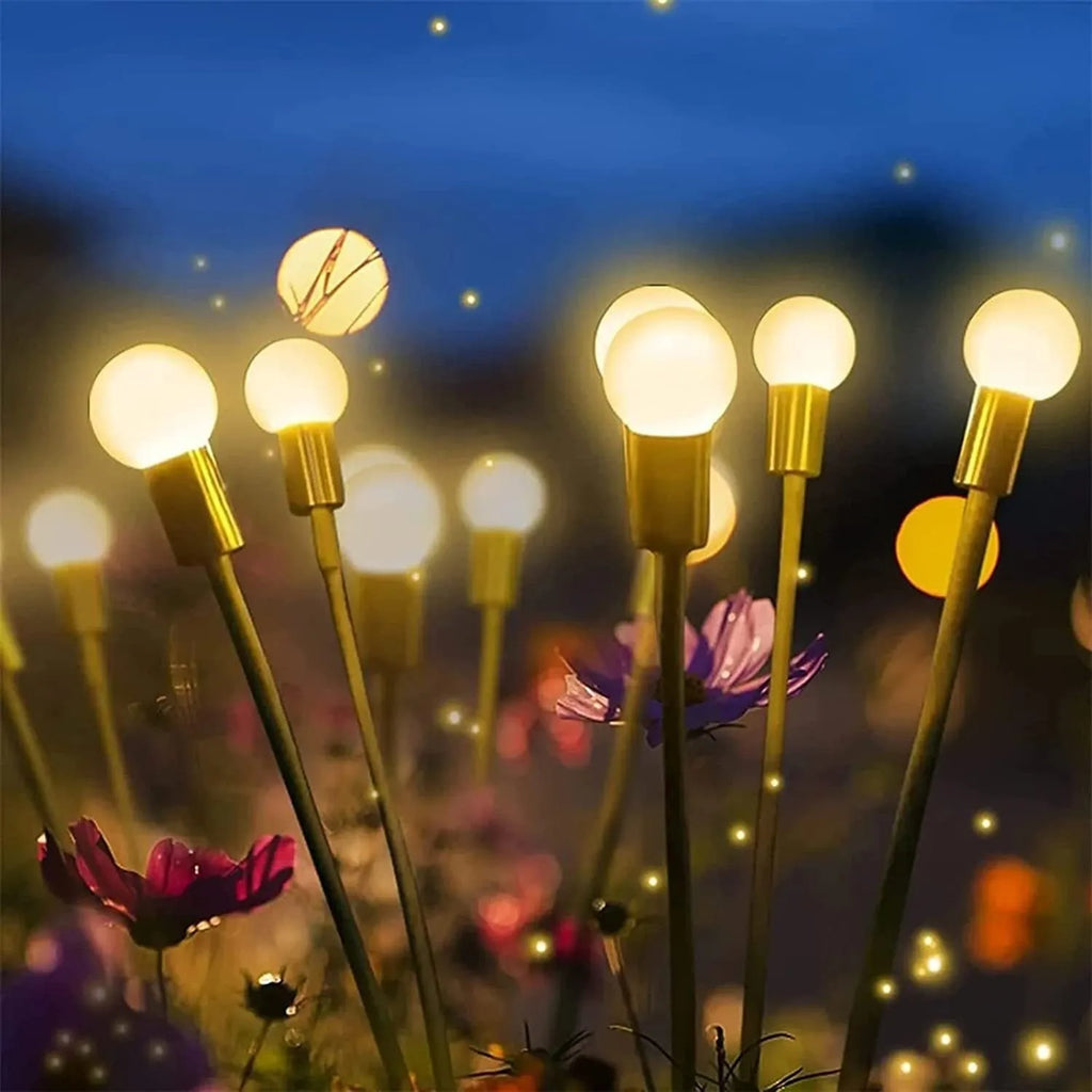 Solar-powered LED ground spike garden light with multiple heads and stainless steel soil plug.