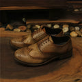 Light brown men's vintage engraved leather casual shoes with distressed finish and lace-up closure.