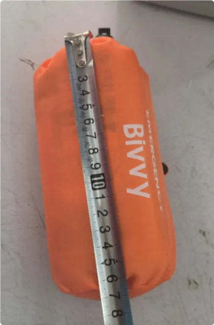Portable orange emergency tent with sleeping bag and whistle for disaster relief camping
