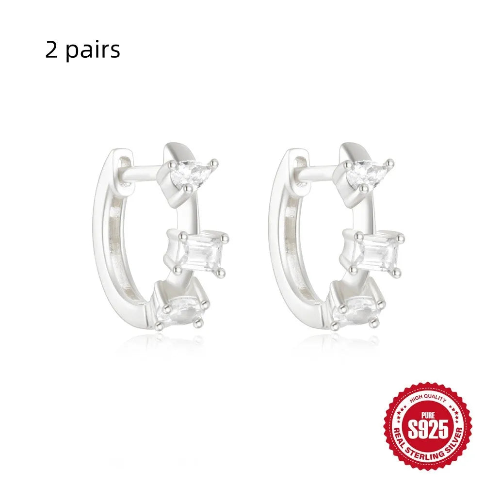 Sterling silver geometric stud earrings with small round design elements in gold or silver finish