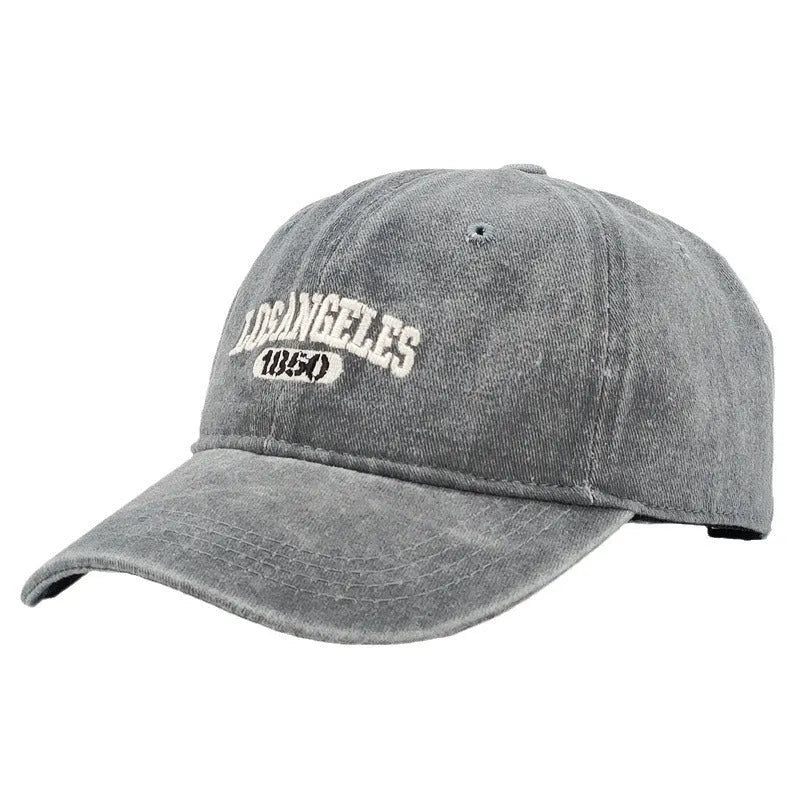 Retro washed distressed embroidered peaked cap with adjustable strap on a conical crown.