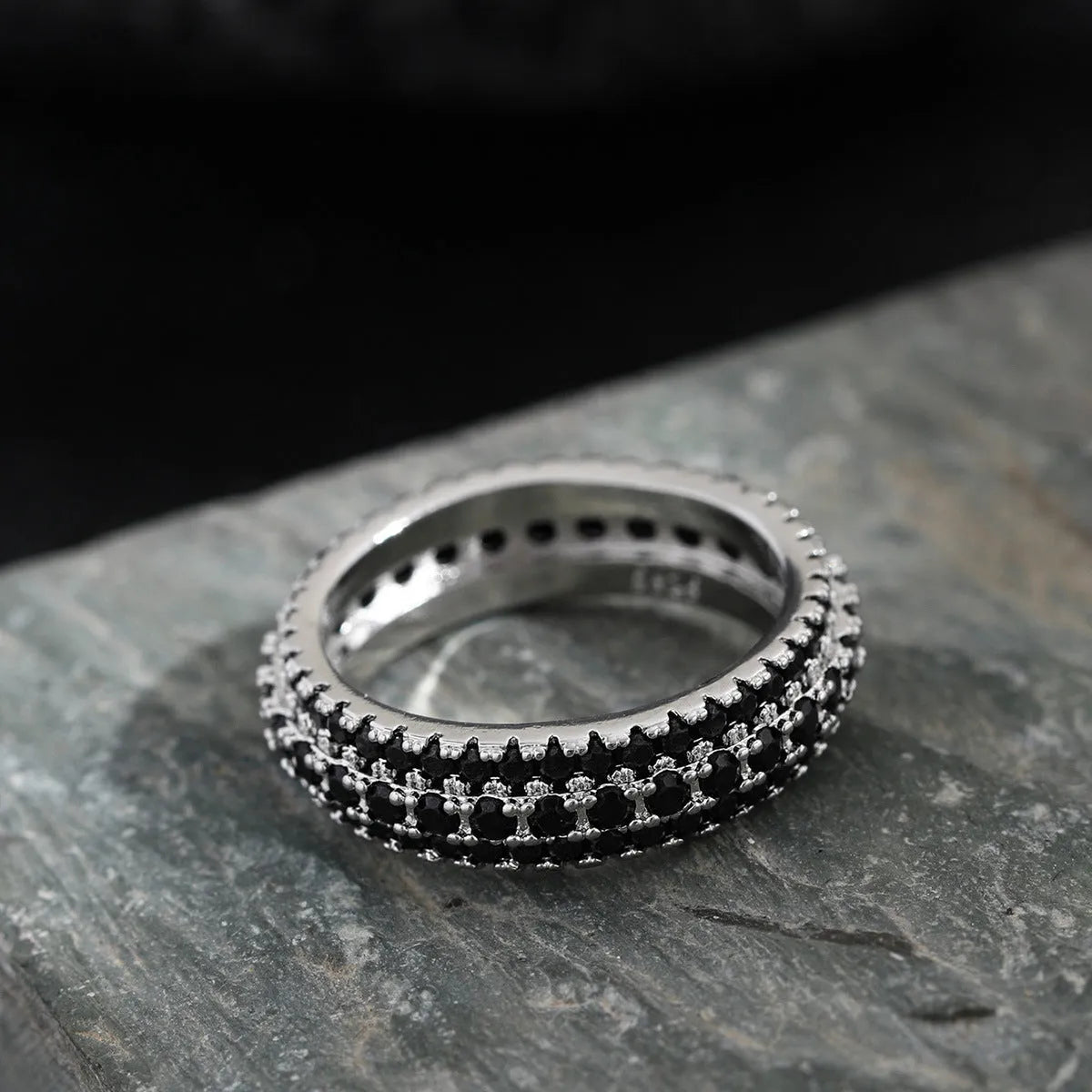 Geometric triangle design engagement ring with zircon stone inlay, shown in different metal plating finishes.