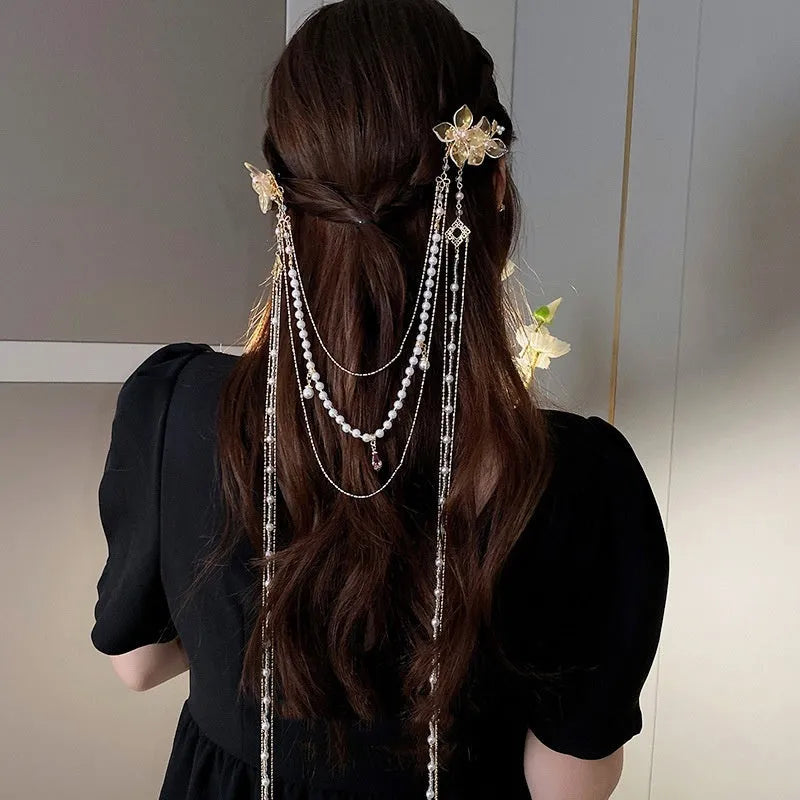 Gold women's hairpin with acrylic pearl, diamond flower decoration, and long dangling tassel.
