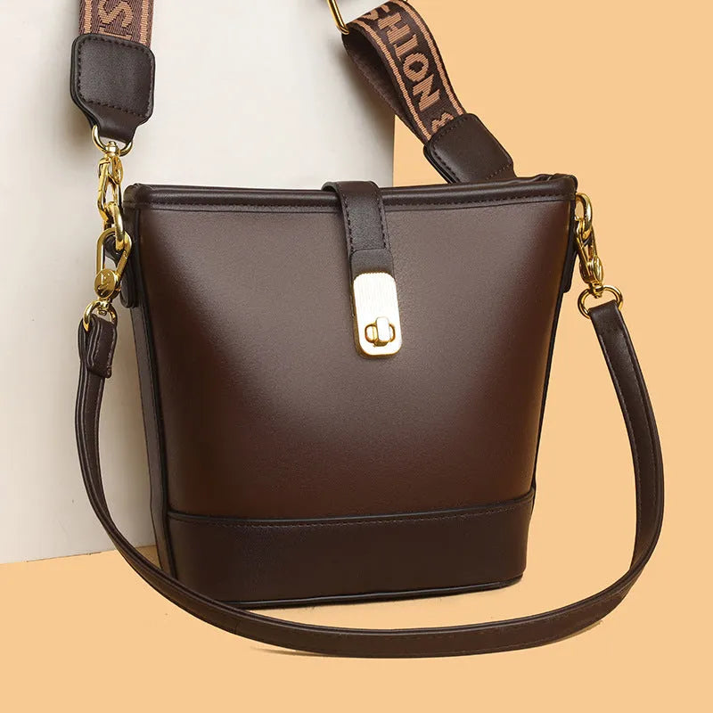Korean style soft PU bucket messenger bag with adjustable straps in black showing internal zipper compartments