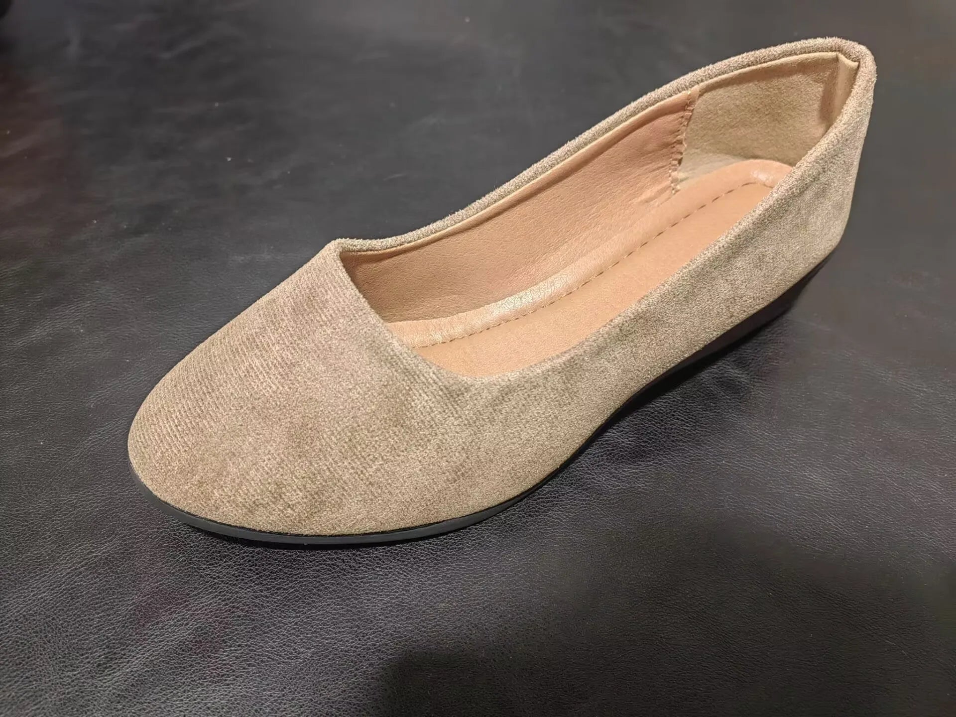 Women's pointed toe suede wedge pumps in light brown with a shallow mouth cut and low rubber sole.