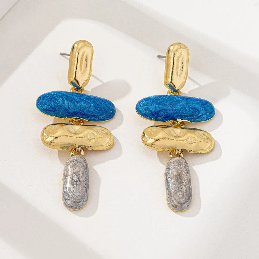 A pair of simple geometric stud earrings with a multicolour metallic finish.