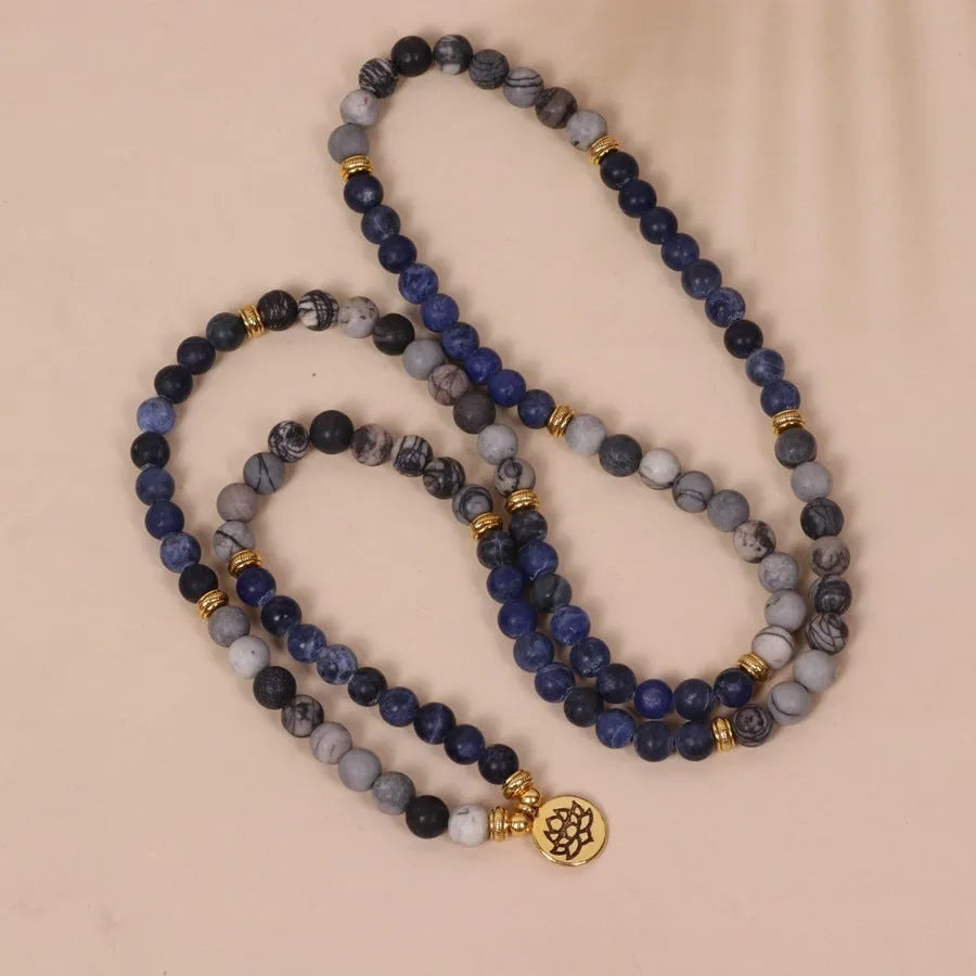 Close-up of a blue patterned network stone bead multi layer alloy bracelet on a wrist