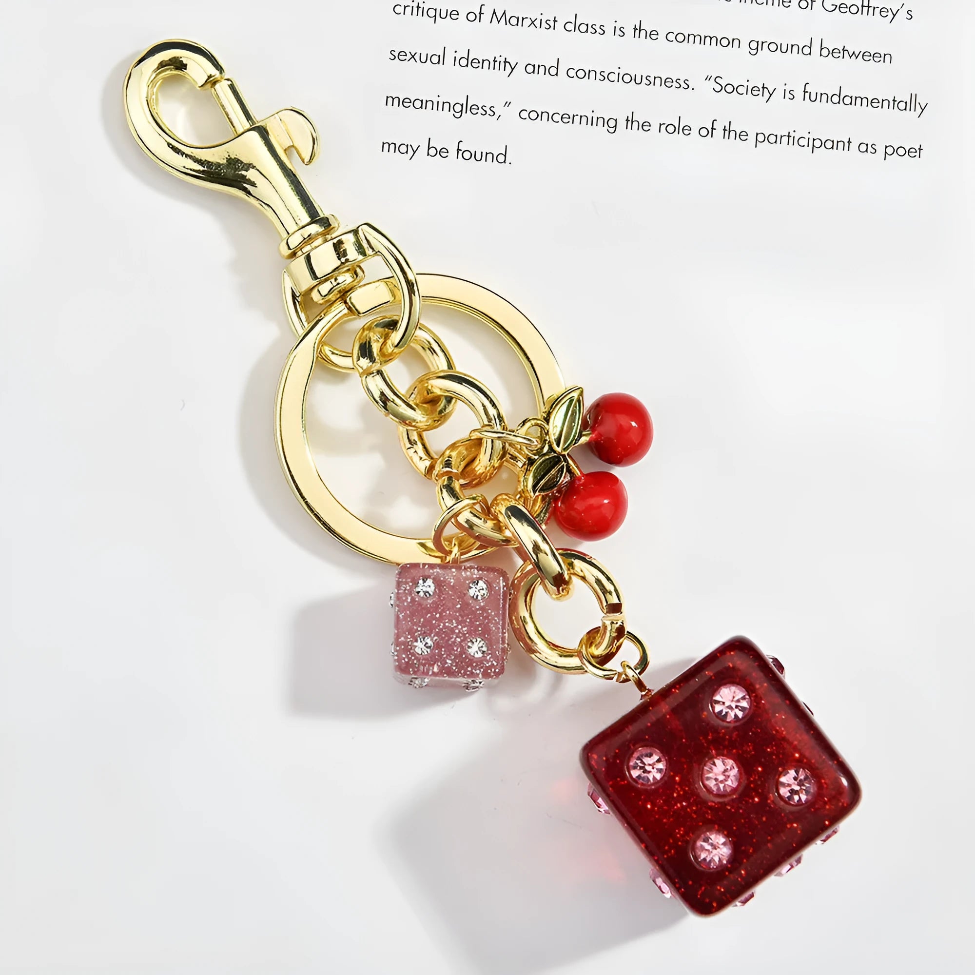 Square metal keychain pendant with a vintage two-tone cherry dice pattern on a white background.