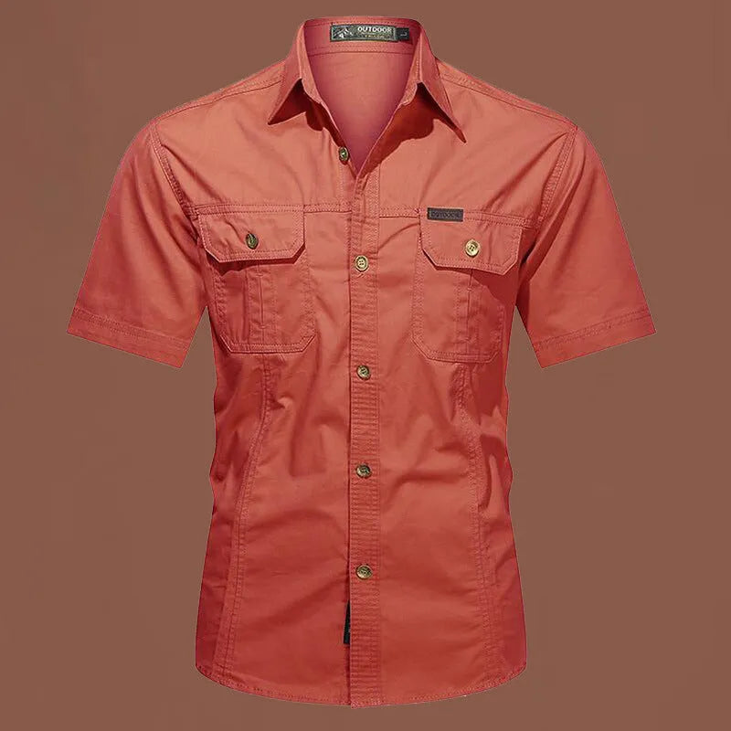 Men's loose-fitting short sleeve cotton work shirt in army green, laid flat.