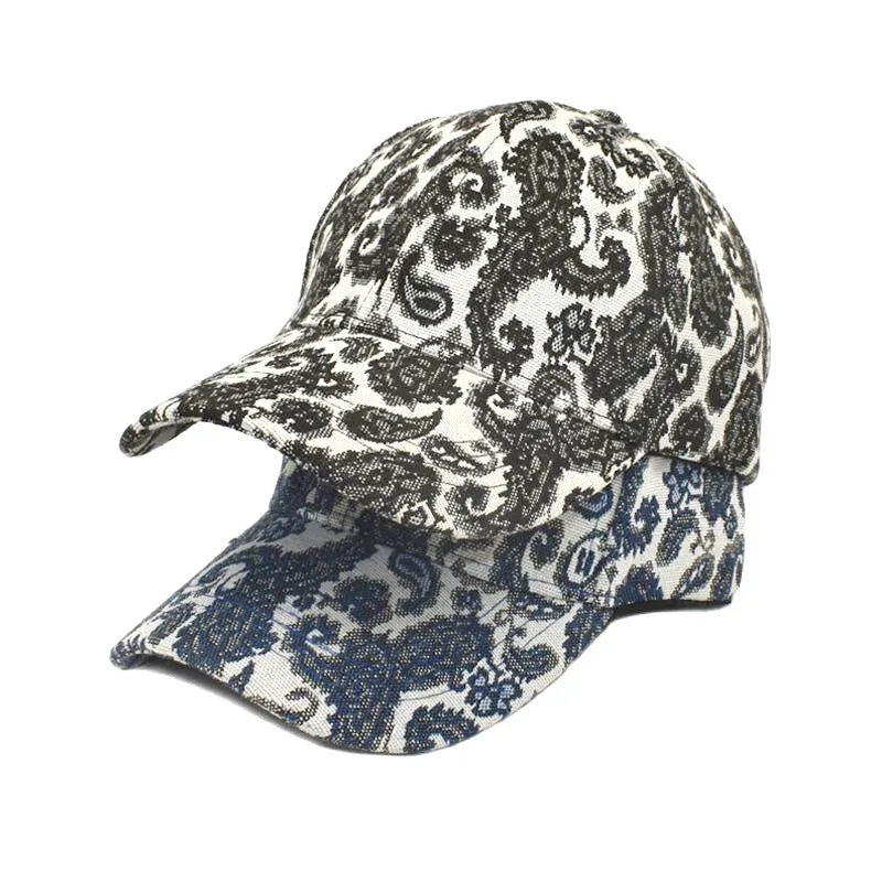 Blue polyester baseball cap with a white paisley pattern, showing the dome crown style.