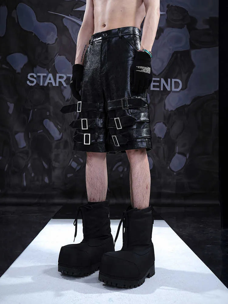 Black men's PU leather-look cropped shorts with a medium-low waist on a mannequin.