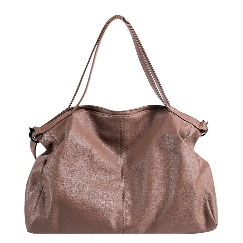 Large soft PU leather messenger bag in khaki colour with adjustable shoulder strap and top handle.