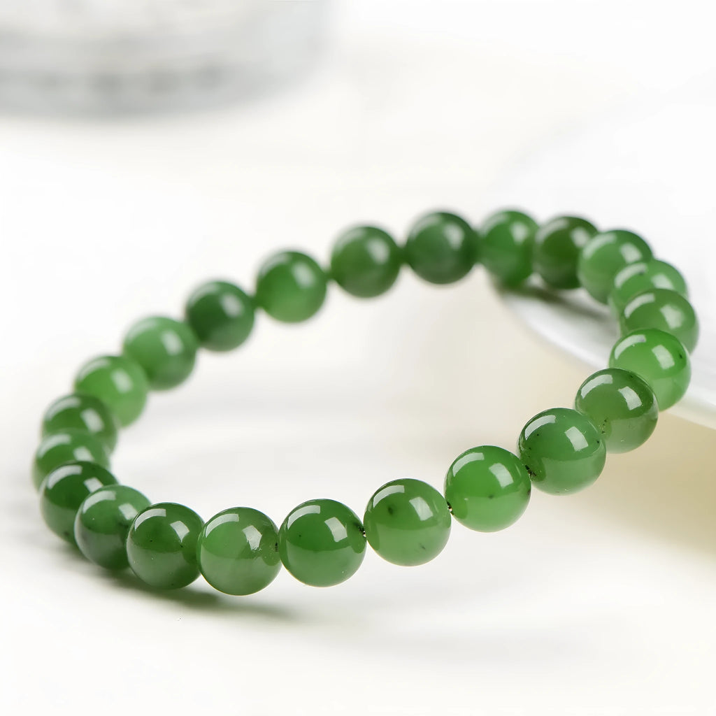 Polished natural Jasper Hetian jade bead bracelet on wrist, showing bead detail.