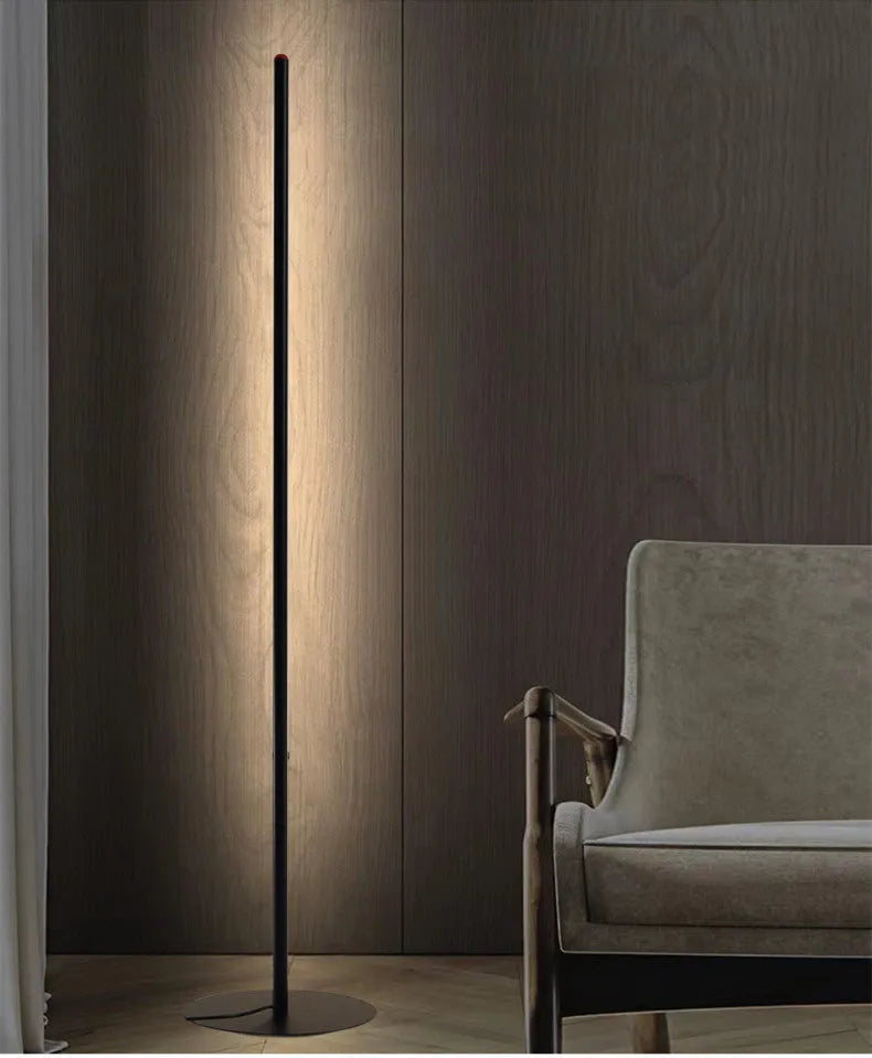 Vertical aluminium alloy floor lamp in modern simple style next to a sofa.