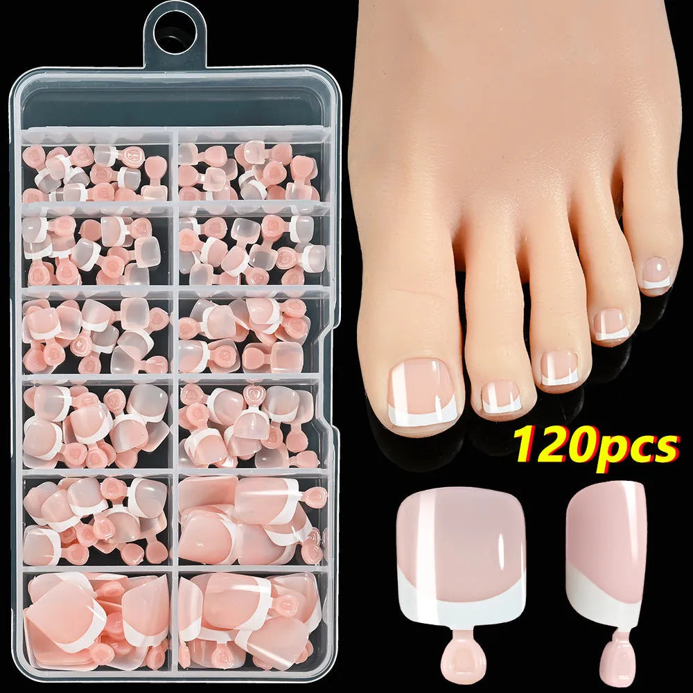 Box of 120 French white edge press-on toe nails in full square short shape showing multiple nude shades.