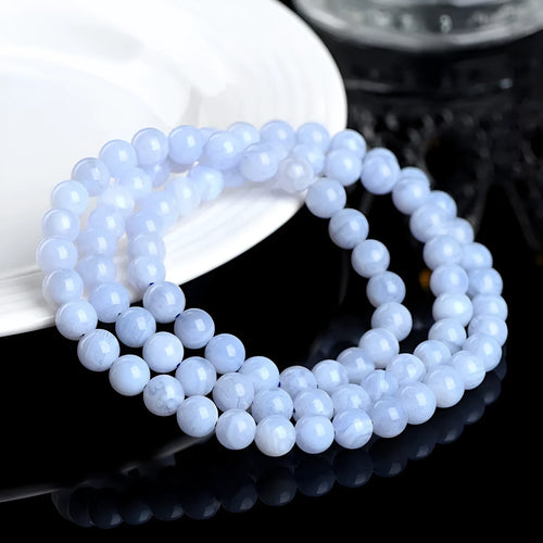 Blue agate bracelet with natural striped pattern and scattered bead design featuring Ruyi elements