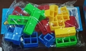 Plastic balance stacking game with 16 coloured building blocks, chassis, and base on a table