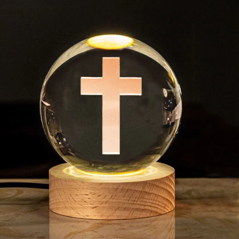 White crystal ball with cross and religious symbols on wooden LED base desk ornament