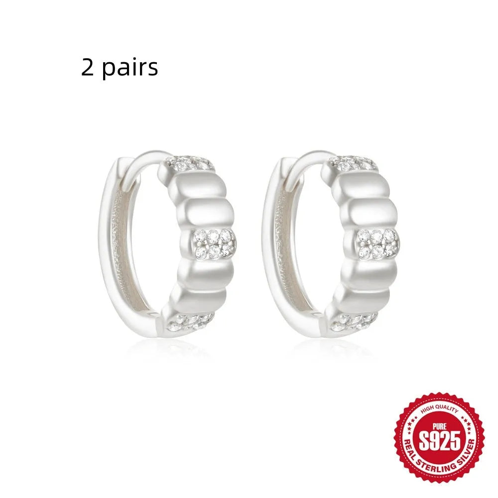 Sterling silver geometric stud earrings with small round design elements in gold or silver finish