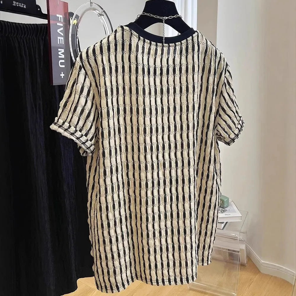 Men's black and white striped short sleeve linen shirt with loose fit pullover style displayed on flat lay