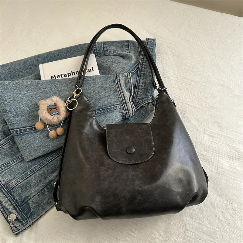 Women's PU leather commuter shoulder bag in horizontal square shape with single strap and optional pendant