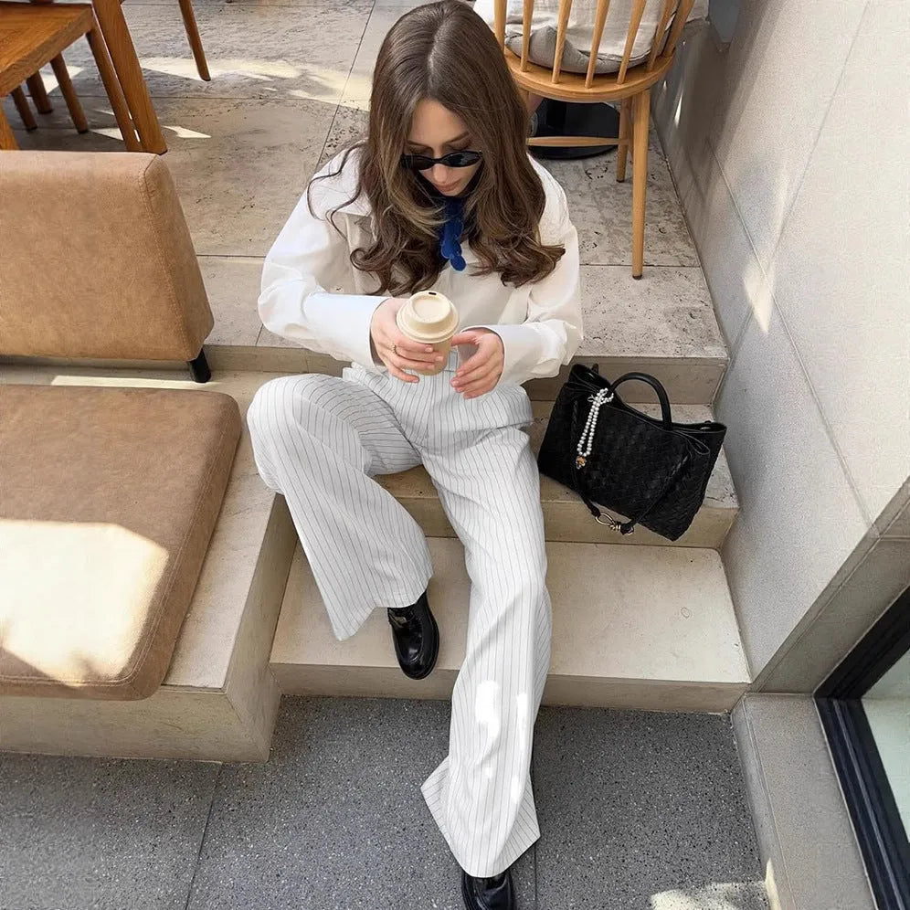 White striped wide-leg trousers with front zipper detail and loose casual fit