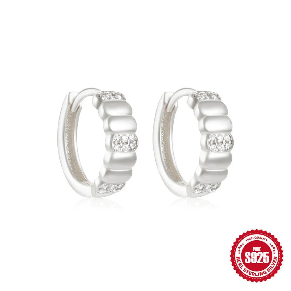 Sterling silver geometric stud earrings with small round design elements in gold or silver finish