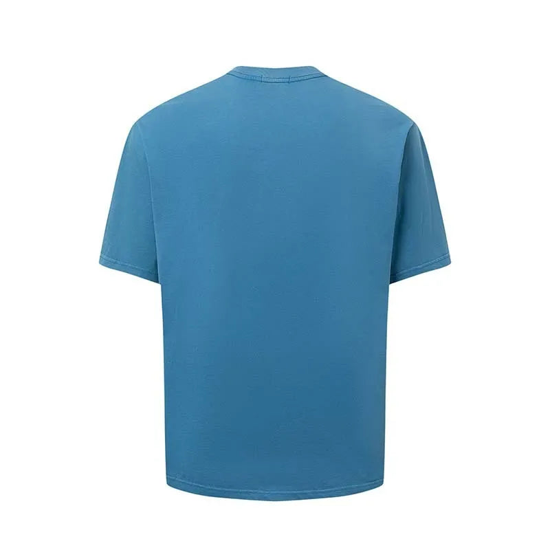 Man wearing a blue loose-fit T-shirt with a large white American retro style letter print on the front.