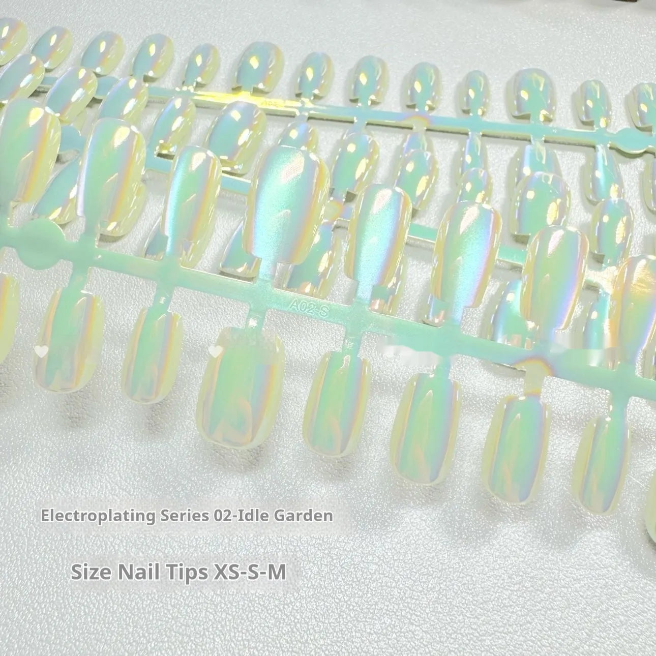 Set of electroplated Cat's Eye press-on false nails in short ladder length on a nail wheel.